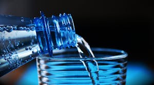 Close-up of Bottle Pouring Water on Glass